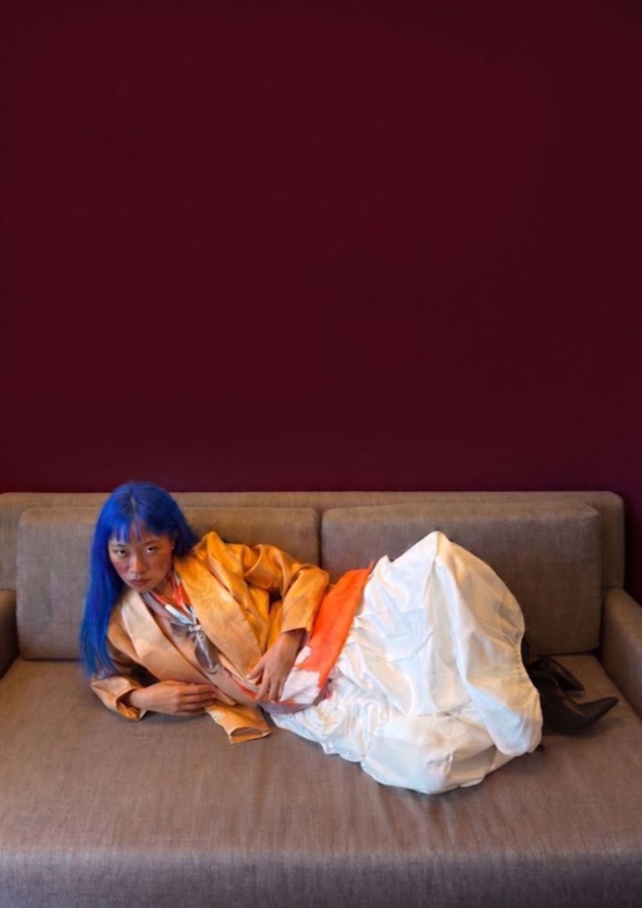 Apricot suiting and a cream skirt on a low couch