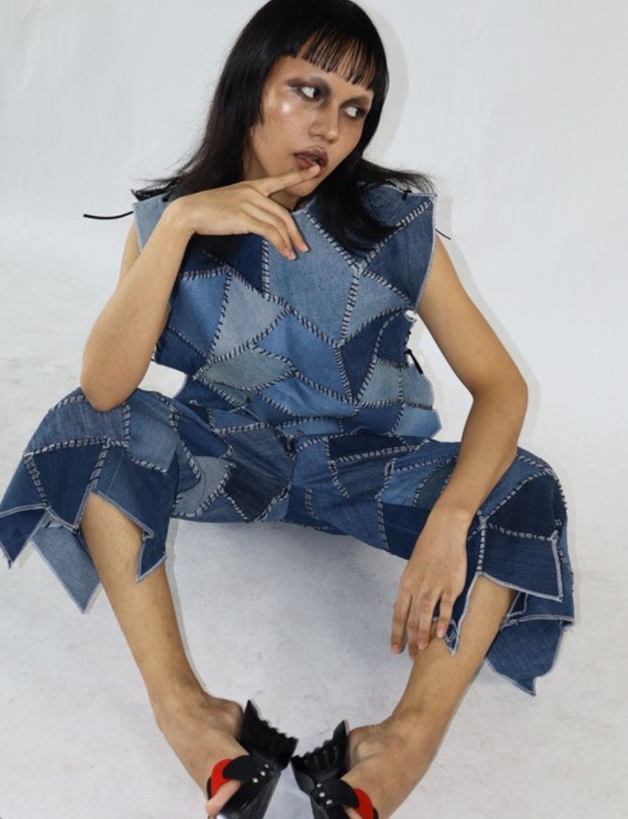 Seated in patchwork denim